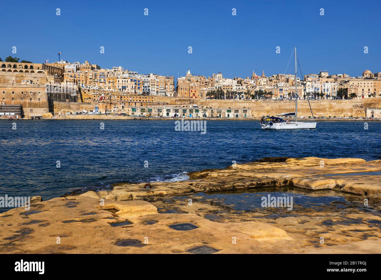 Malta, Valletta, View of city from Birgu side with sailboat on Grand Harbour Stock Photo