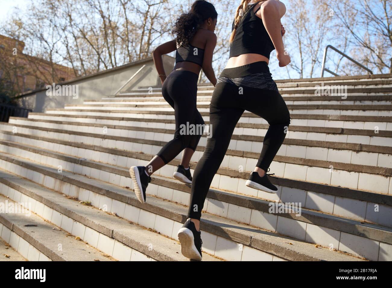 Two sportswomen during workout on stairs Stock Photo