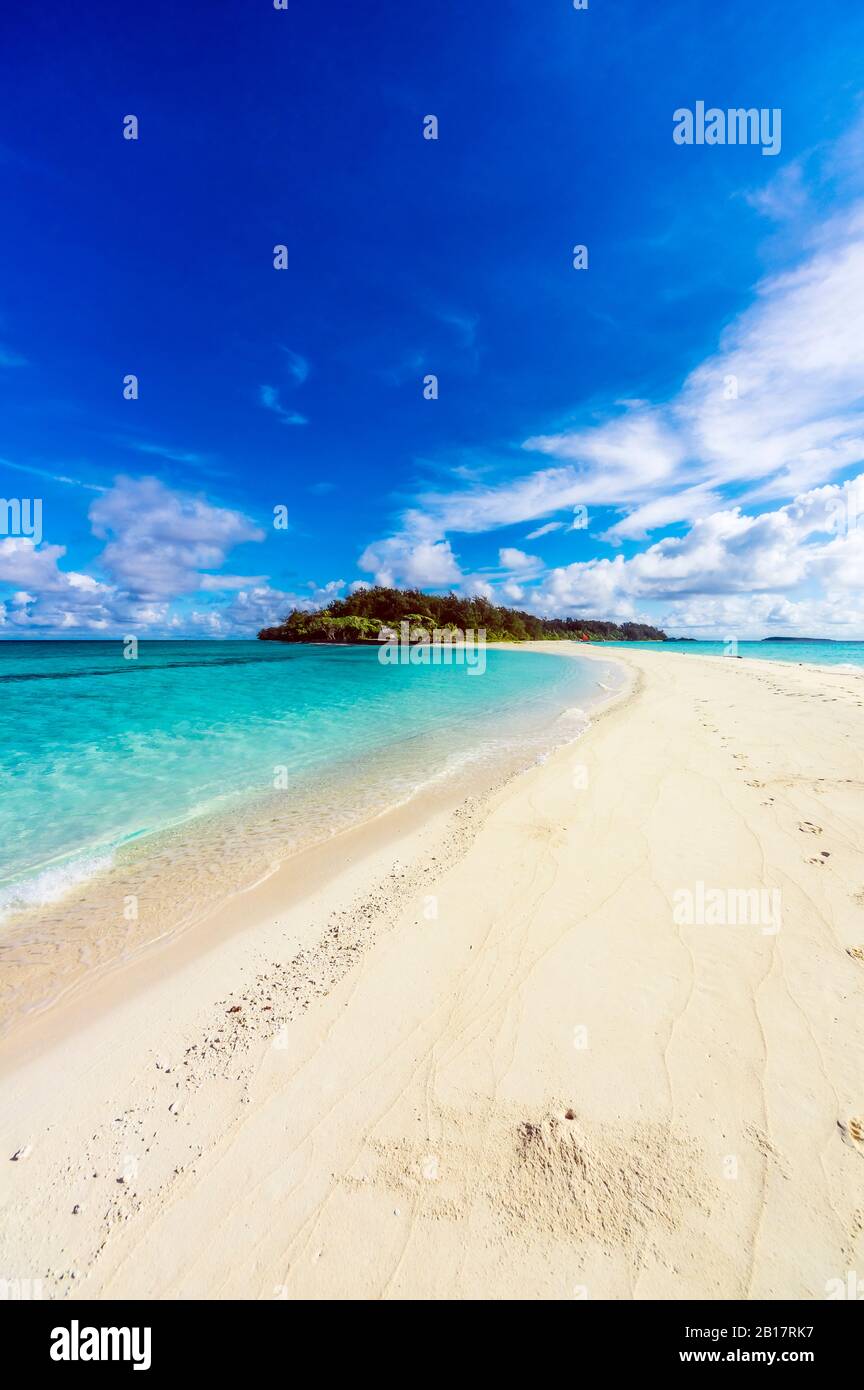 Papua New Guinea, Milne Bay Province, Blue sky over sandy coastal beach ...