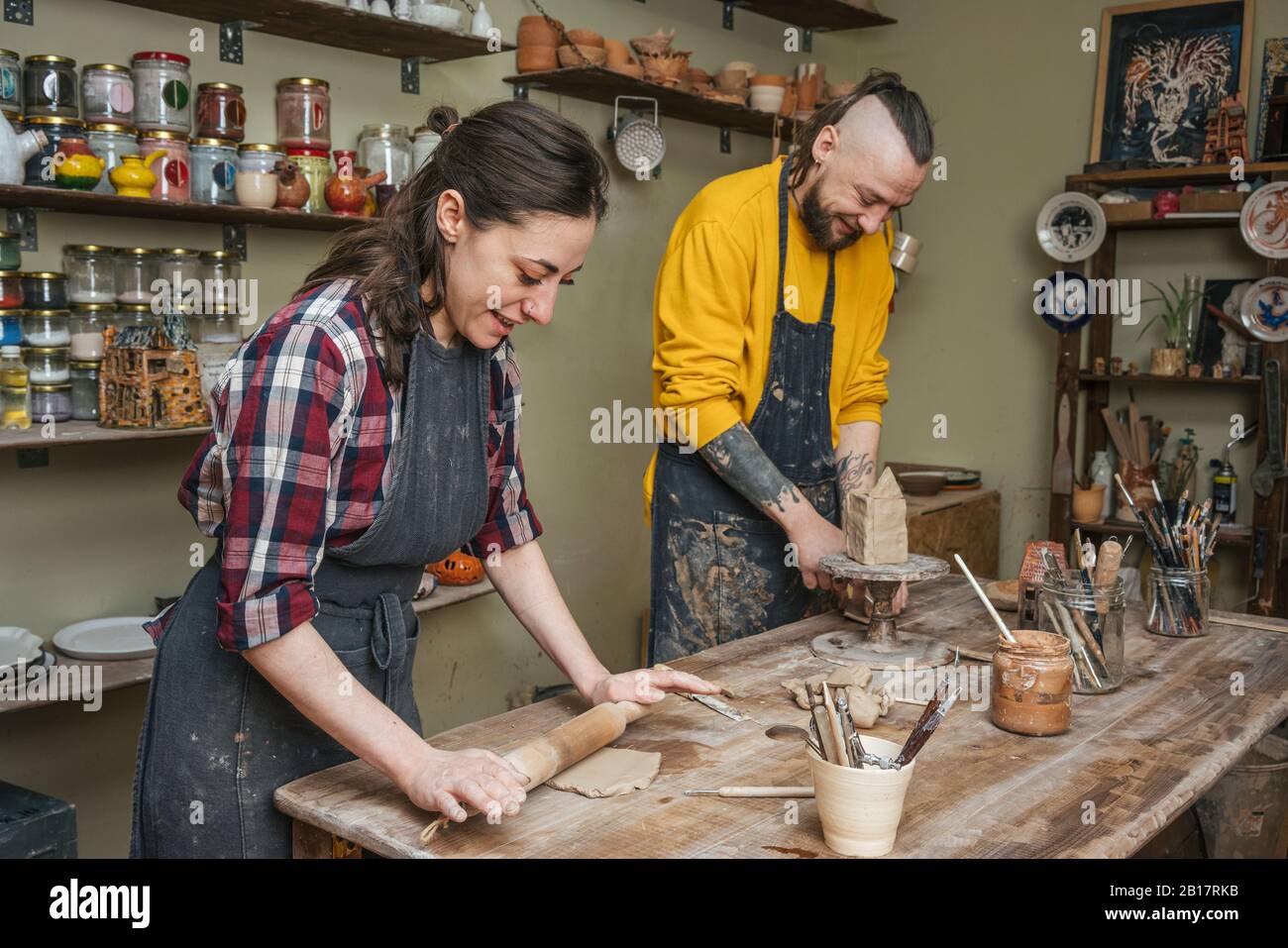 Two potters working together in workshop Stock Photo
