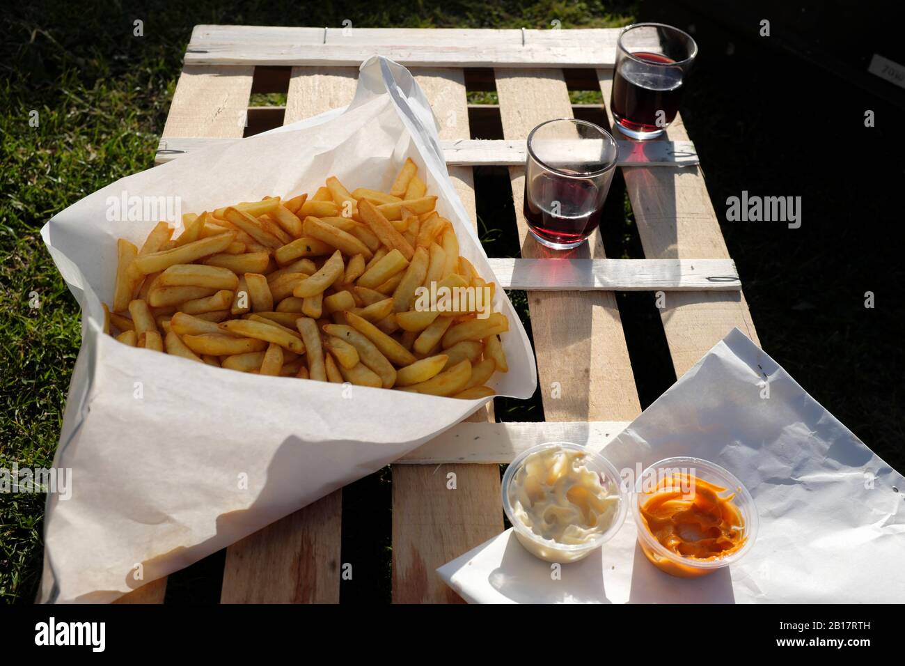 France, Brittany, Audierne, French fries with mayonnaise, ketchup and red wine - picnic on wooden crate Stock Photo