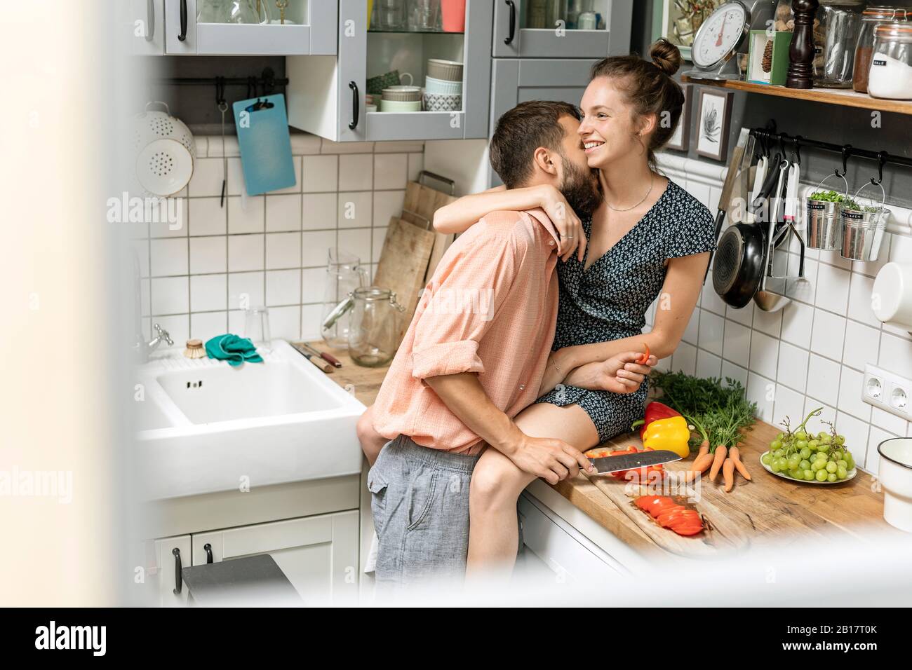 Affectionate couple in kitchen, preparing food Stock Photo