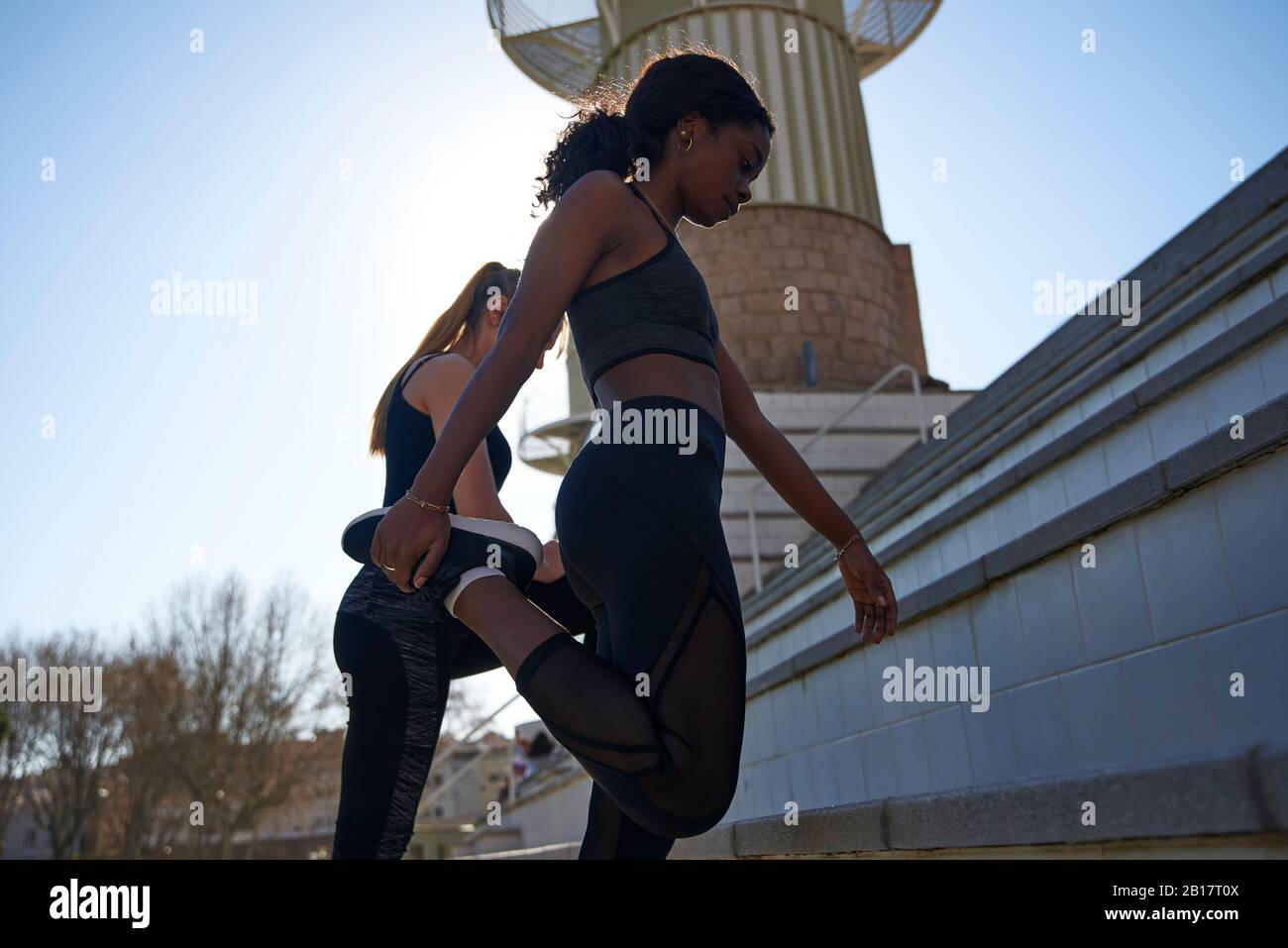 Two women exercising together outdoors Stock Photo