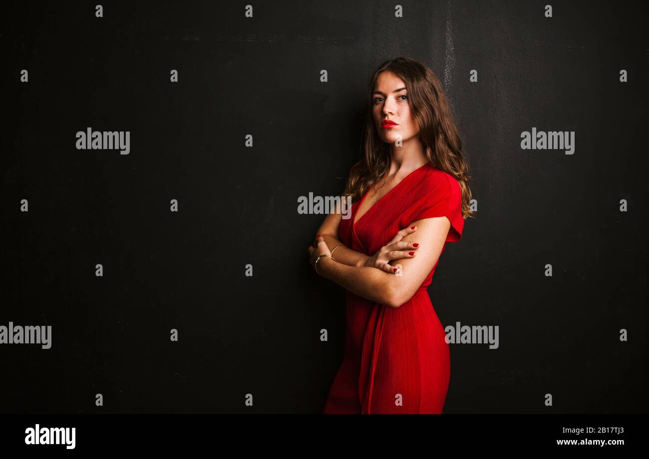 Portrait of young woman wearing red dress Stock Photo