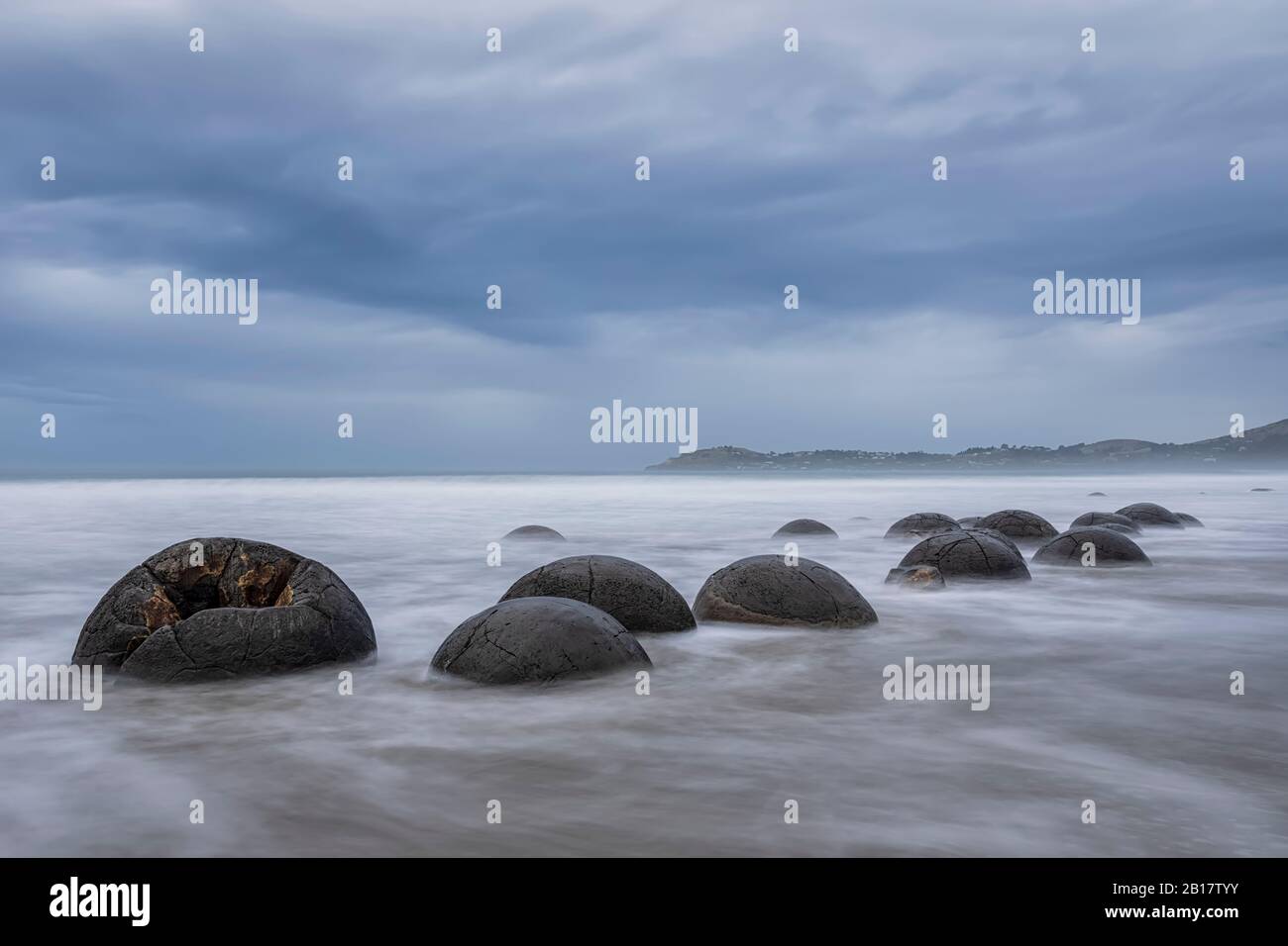 New Zealand, Oceania, South Island, Southland, Hampden, Otago, Moeraki, Koekohe Beach, Moeraki Boulders Beach, Moeraki Boulders, Round stones on beach at dusk Stock Photo