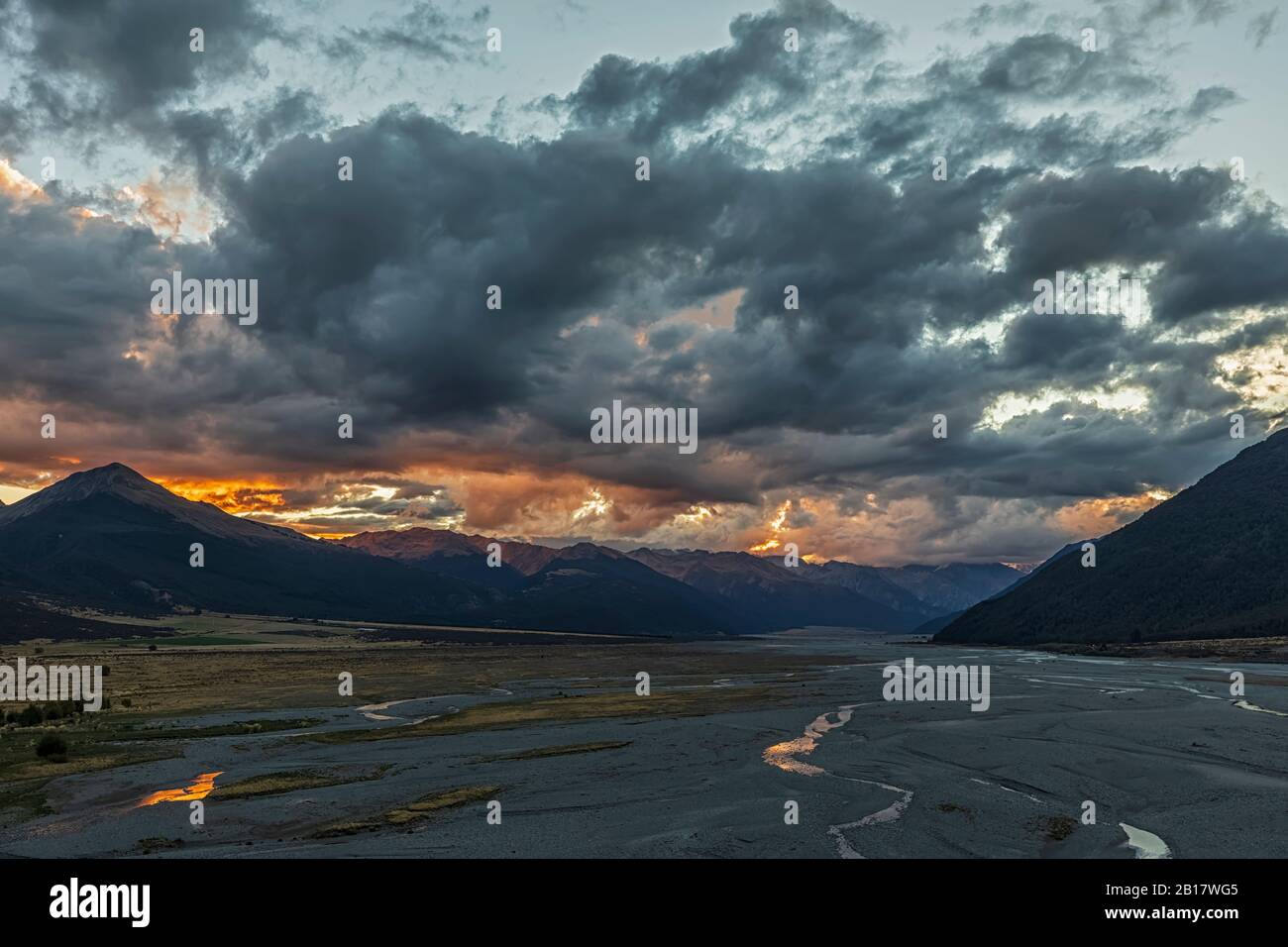 New Zealand, Grey District, Inchbonnie, Clouds over Waimakariri River in Arthurs Pass National Park at dusk Stock Photo