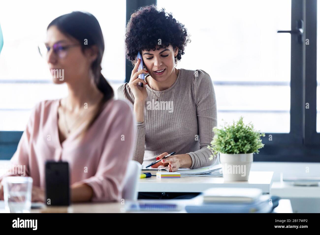 Businesswoman phoning at the office Stock Photo