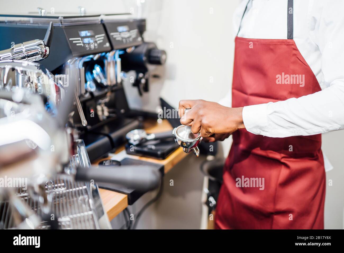Close-up of barista at work in a coffee shop Stock Photo
