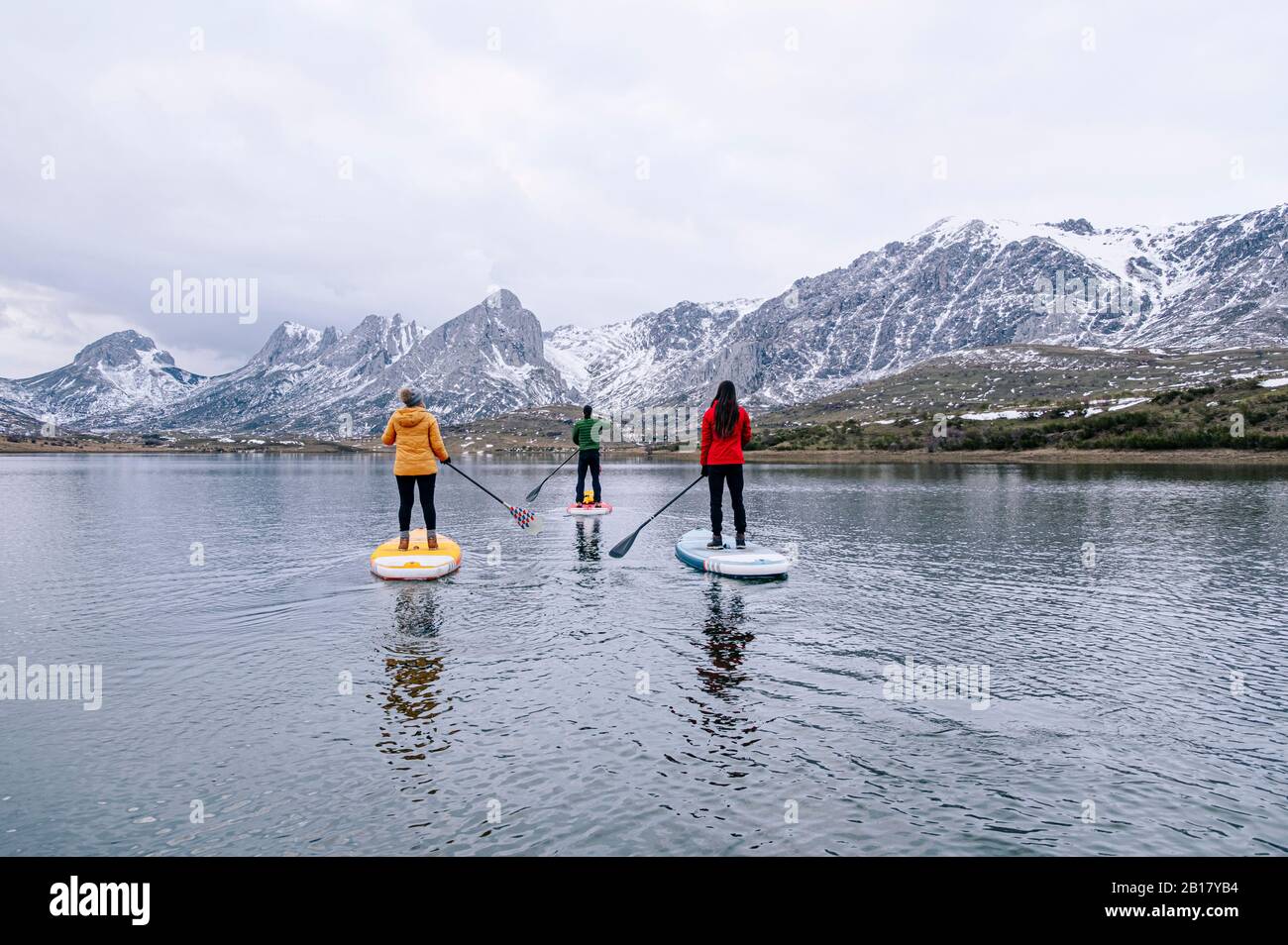Three people stand up paddle surfing, Leon, Spain Stock Photo