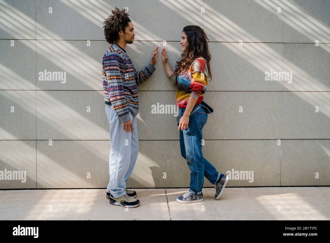 Couple of dancers face to face in front of a wall Stock Photo