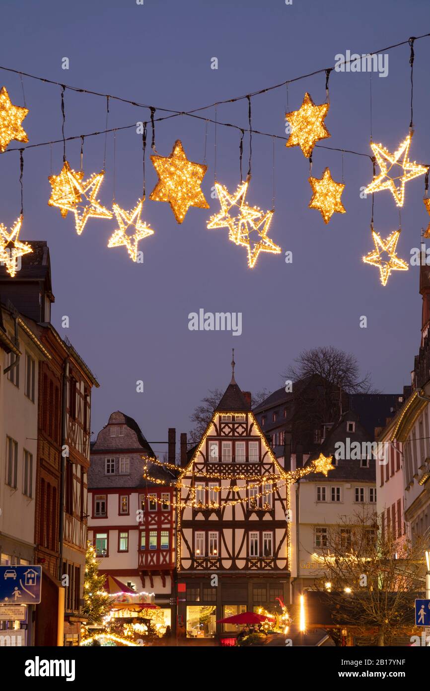 Germany, Hesse, Limburg an der Lahn, Christmas decorations glowing over market square at dusk Stock Photo
