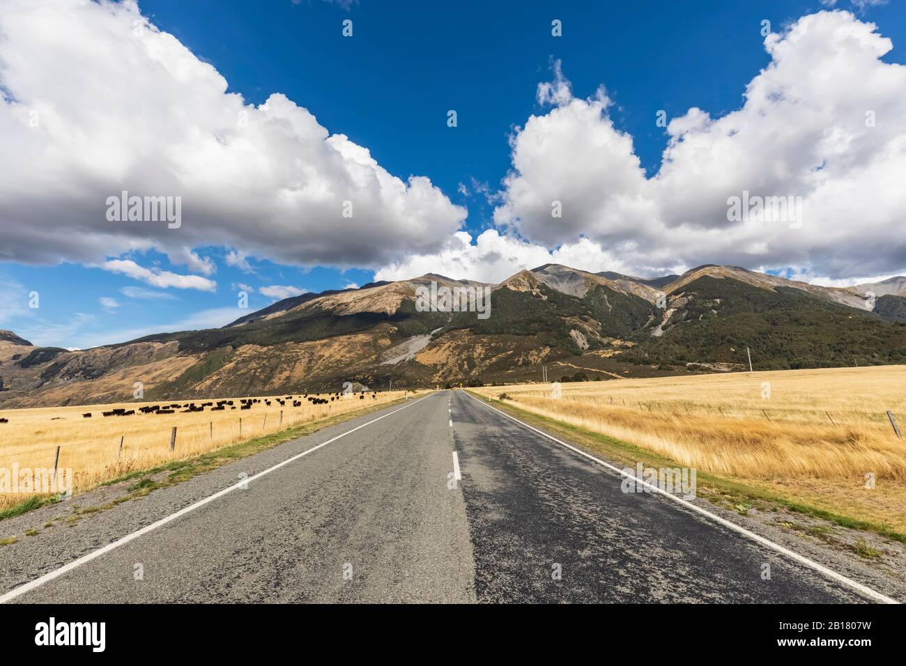 New Zealand, Grey District, Inchbonnie, Clouds over empty State Highway 73 with mountains in background Stock Photo