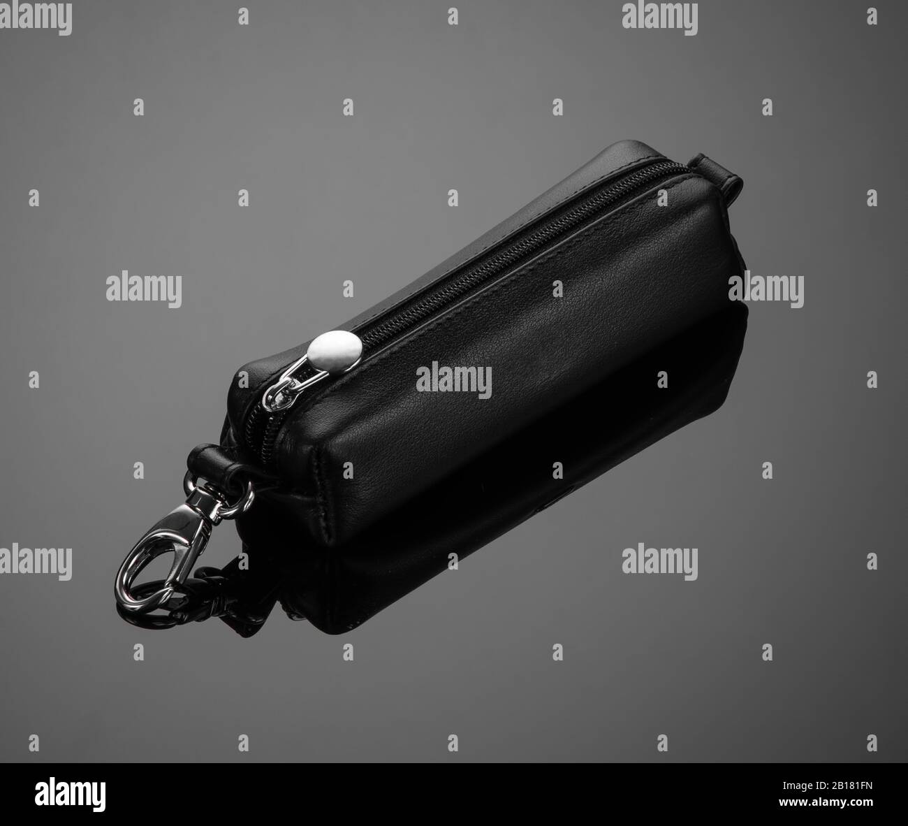 leather key case with zipper on black background Stock Photo