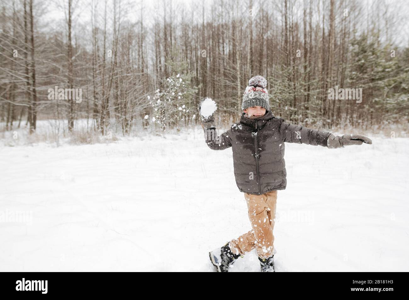 Boy throwing snowball Stock Photo Alamy