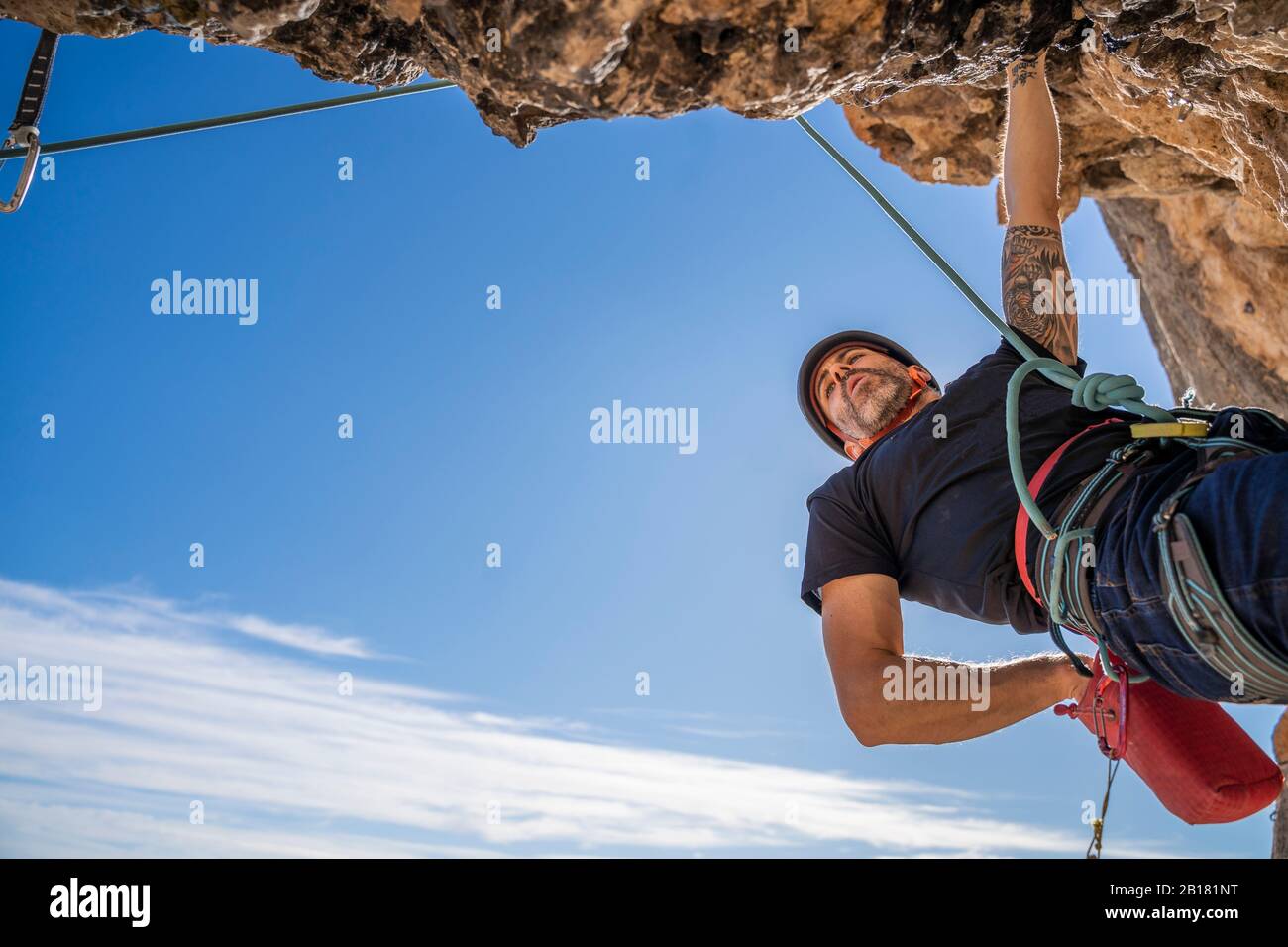 Man climbing at rock face Stock Photo