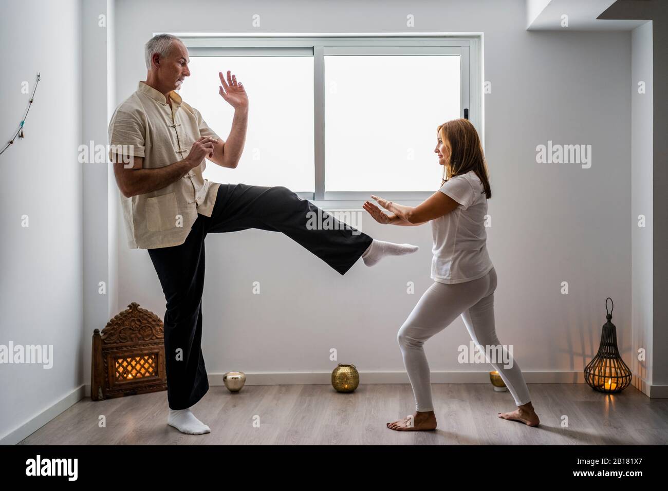 Man and woman practicing martial arts in gym Stock Photo