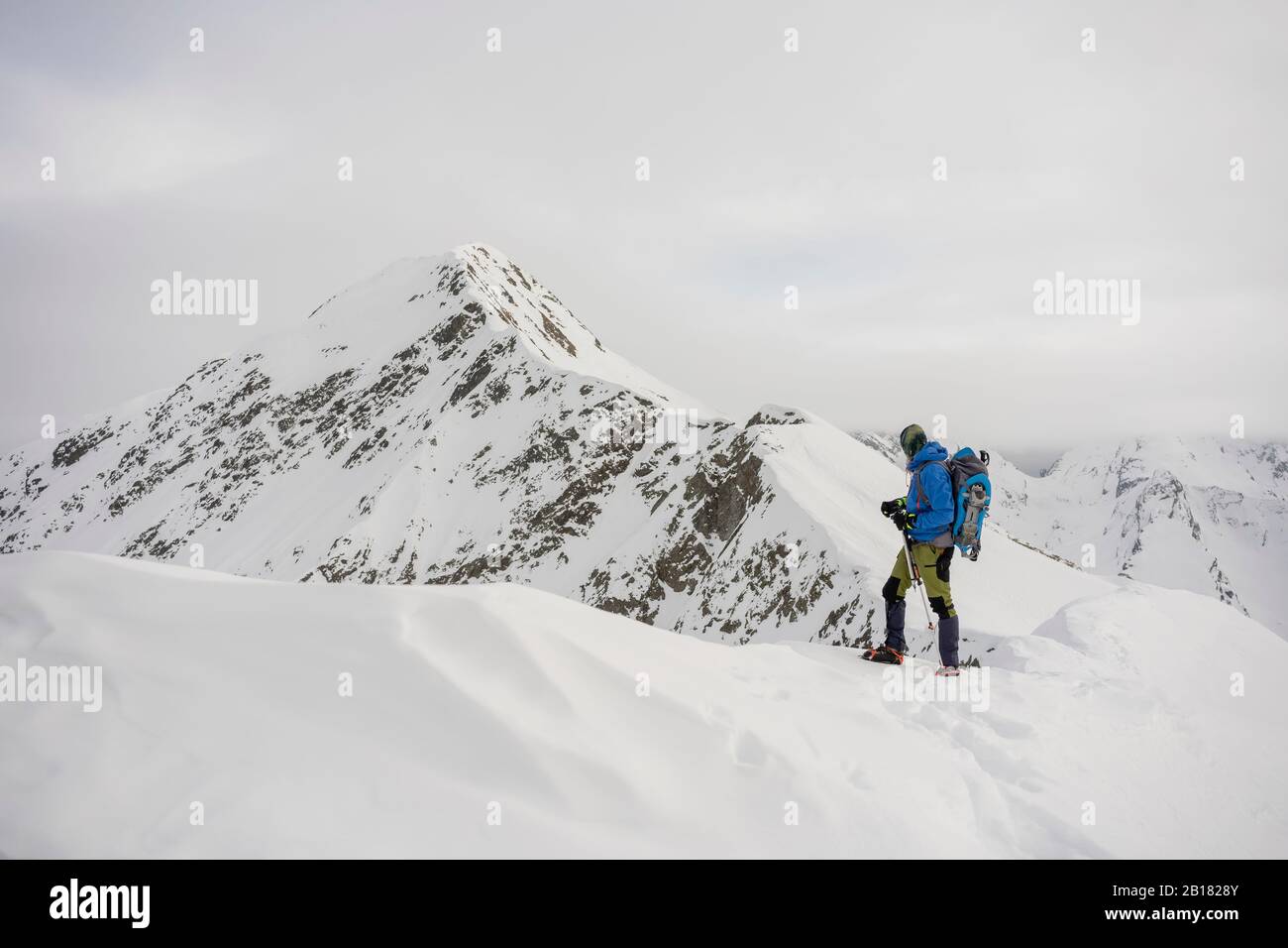 Man on an excursion on the crest of a snowy mountain, Lombardy, Valtellina, Italy Stock Photo