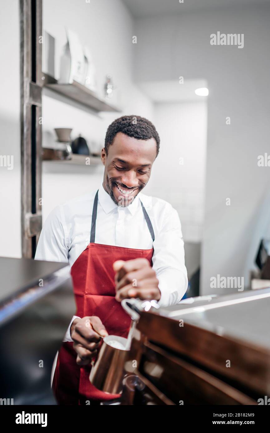 Smiling barista at work in a coffee shop Stock Photo
