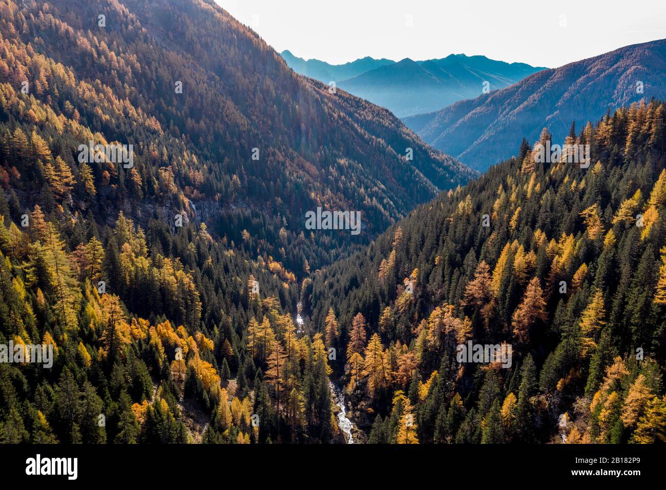 Austria, Carinthia, Aerial view of forested mountain valley in autumn Stock Photo
