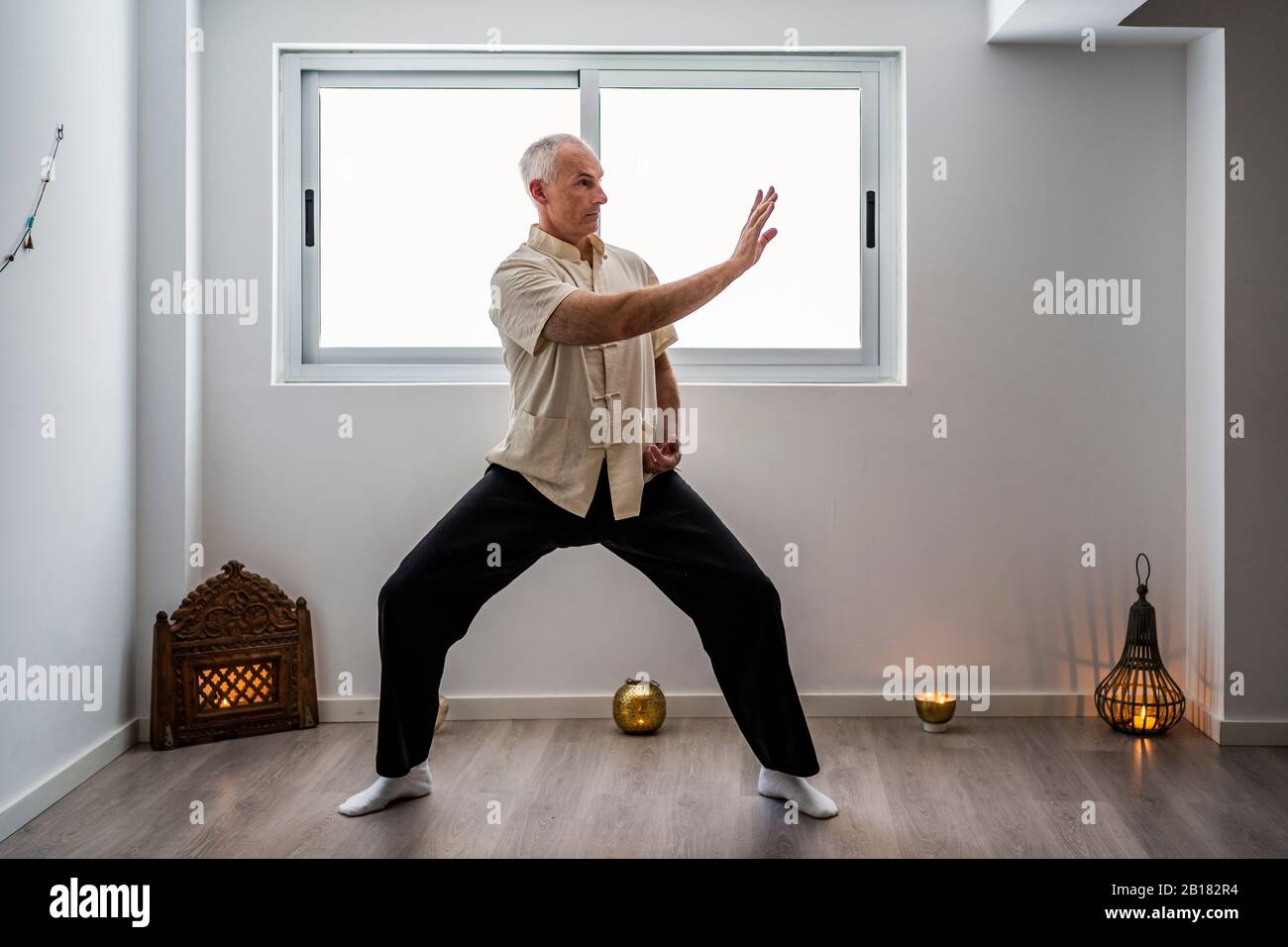 Man practicing martial arts in gym Stock Photo