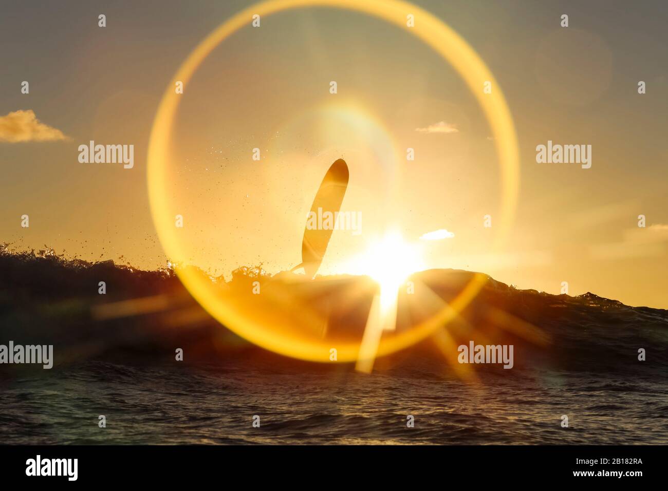 Indonesia, Bali, Surfboard above sea wave at sunset Stock Photo Alamy