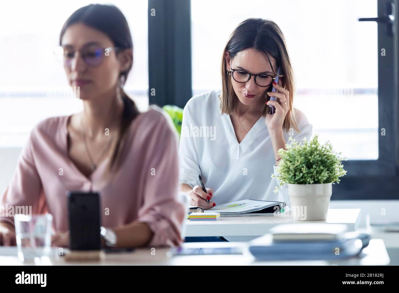 Businesswoman phoning at the office Stock Photo