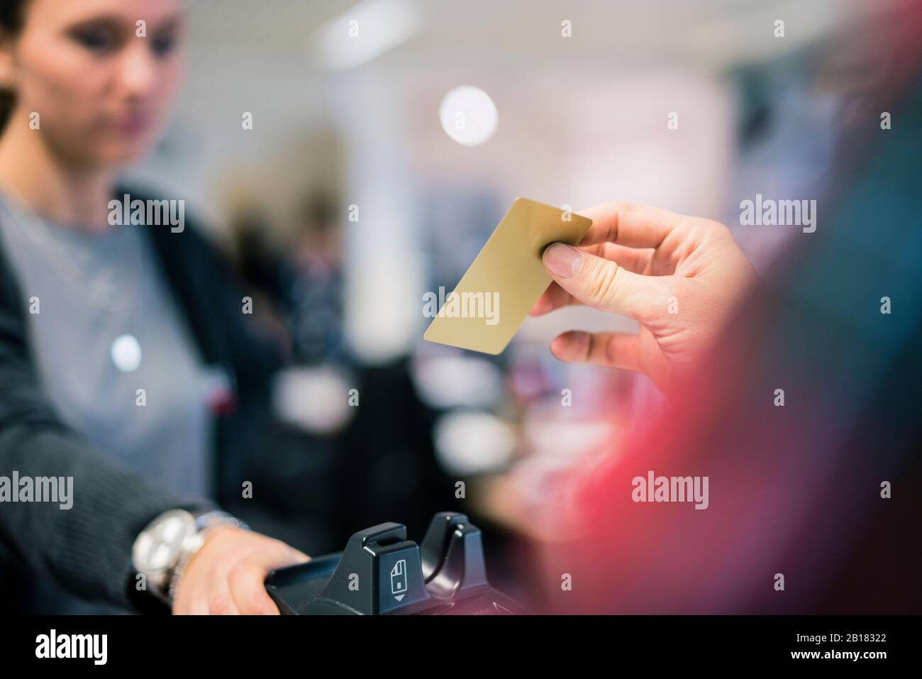 Close-up of man paying with credit card at the counter of a shop Stock Photo