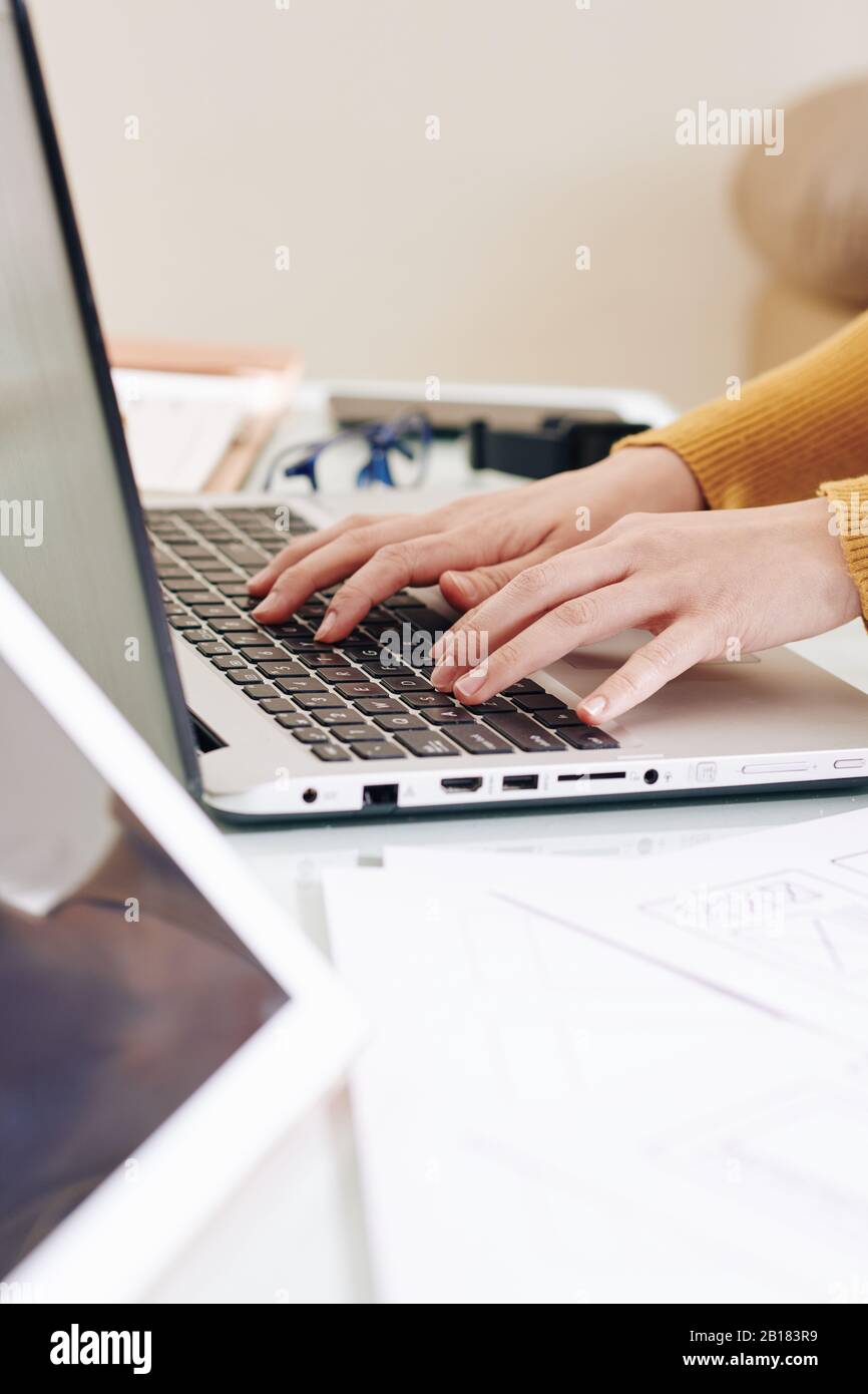 Hands of software developer working on laptop and creating programming code for new application of website Stock Photo