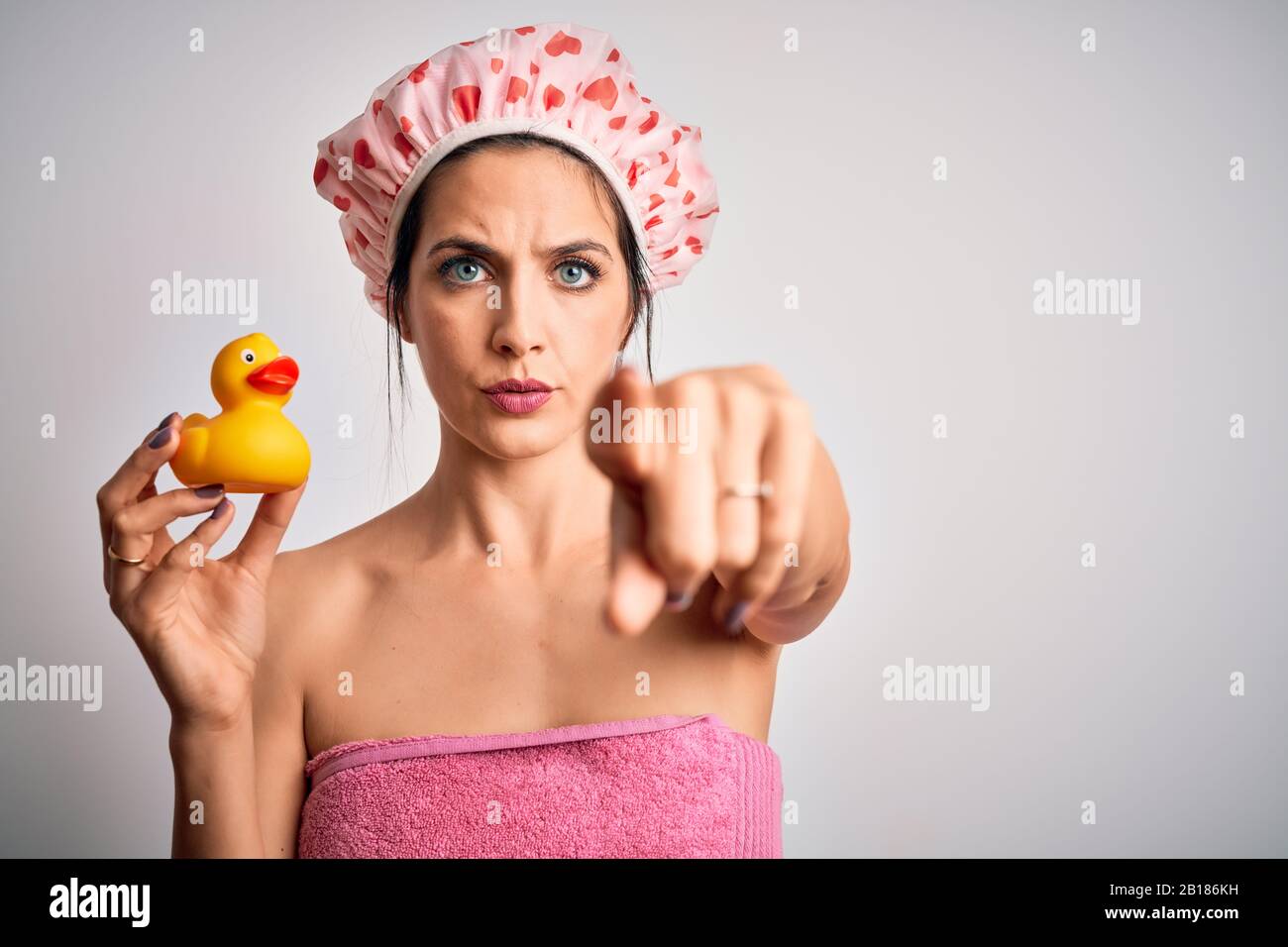 shower cap holding duck toy pointing 