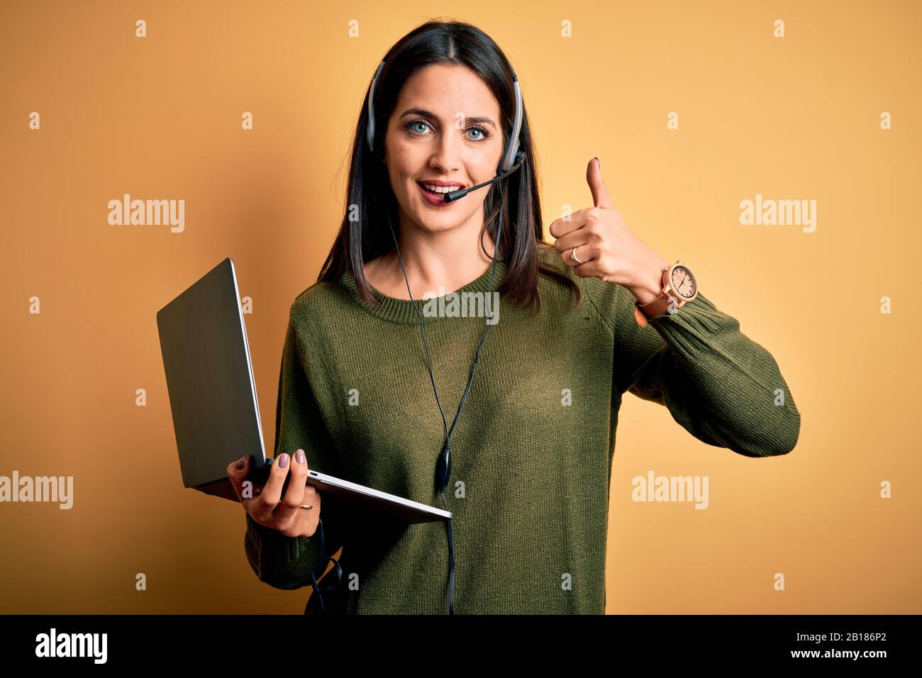 Young operator woman with blue eyes working on call center using ...