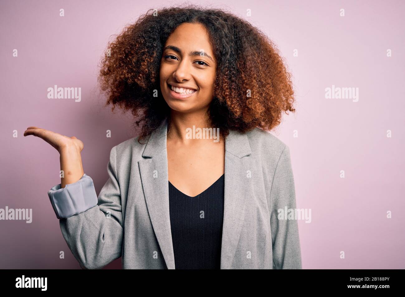 Young african american businesswoman with afro hair wearing elegant ...