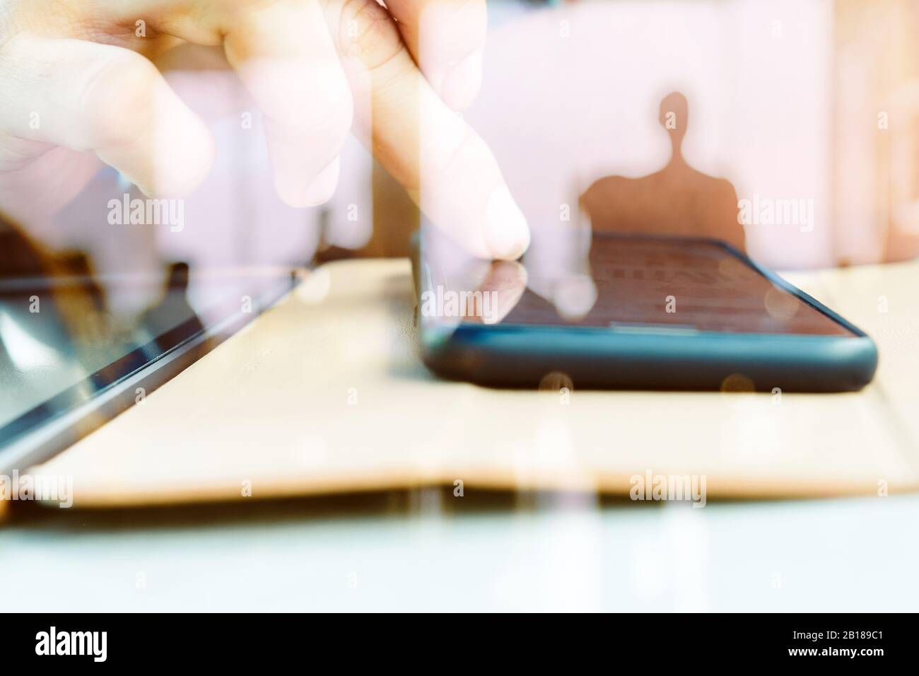 Hands with mobile, double exposure Stock Photo