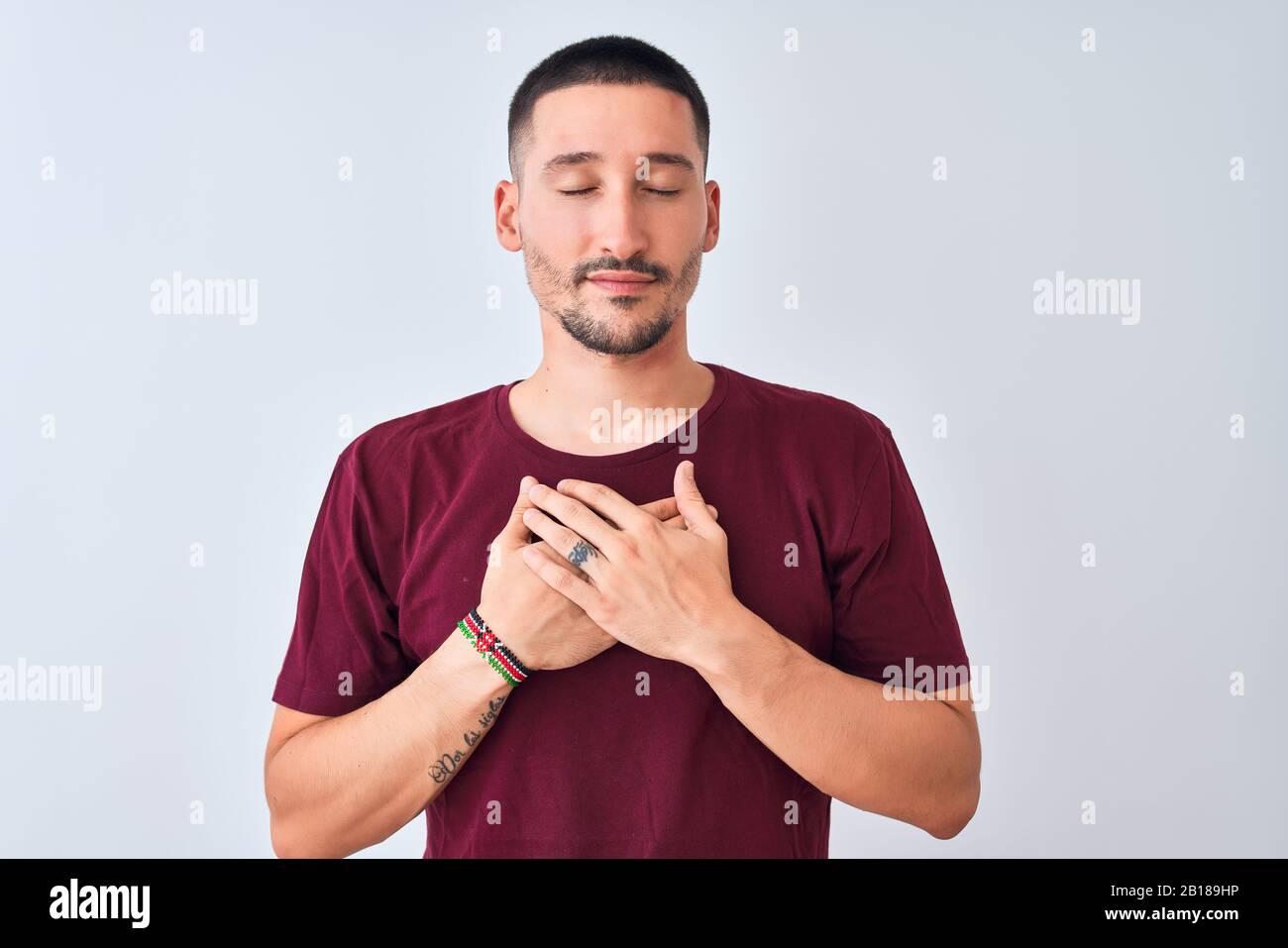 Young handsome man standing over isolated background smiling with hands ...