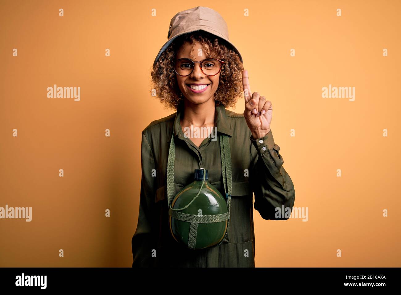 Young african american tourist woman on vacation wearing explorer hat ...