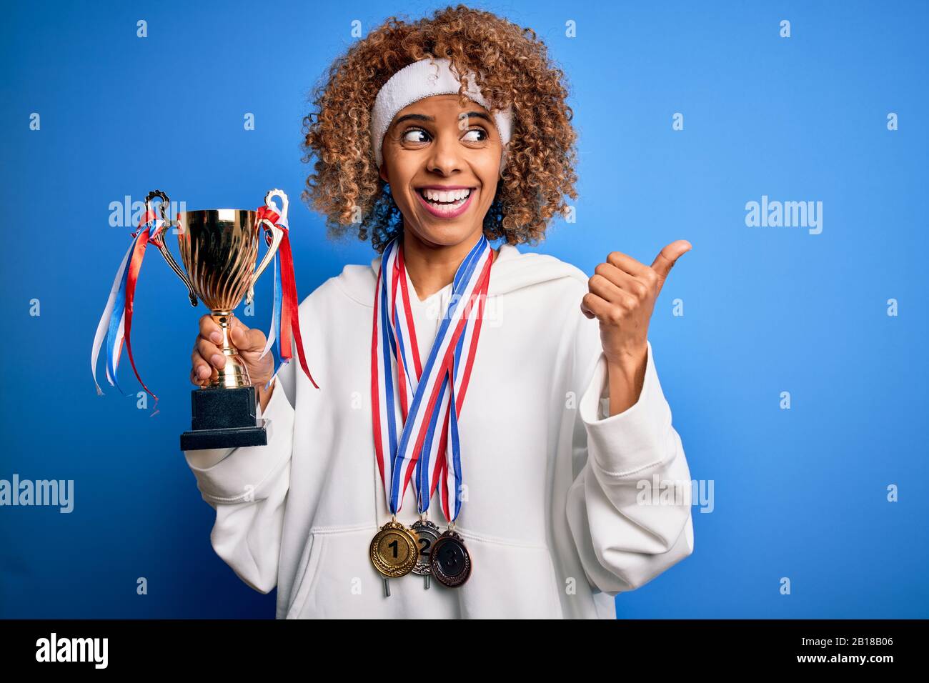 Young african american sporty woman doing sport winning medals and