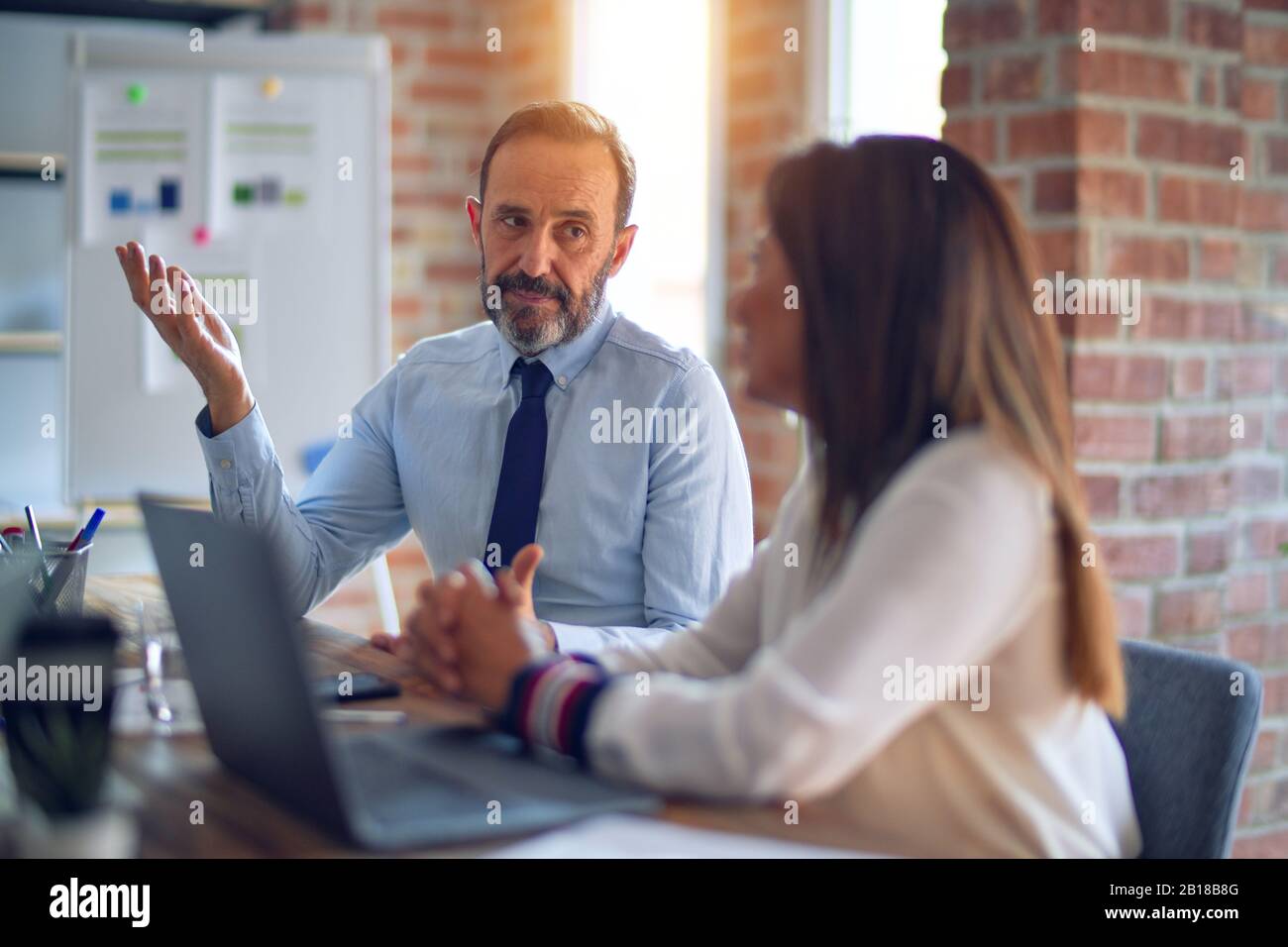 Two middle age business workers smiling happy and confident. Working ...