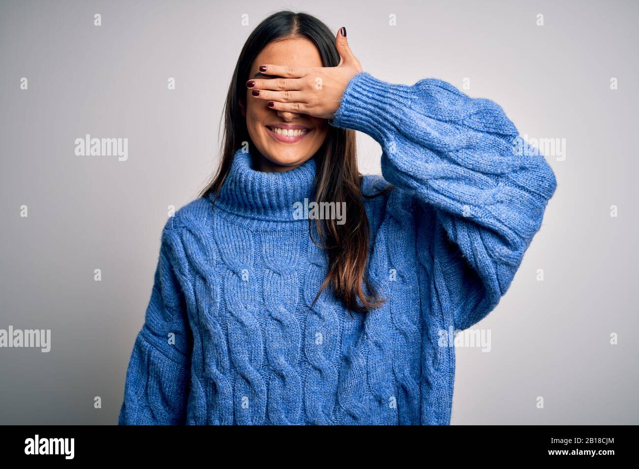 Young beautiful brunette woman wearing casual turtleneck sweater over ...