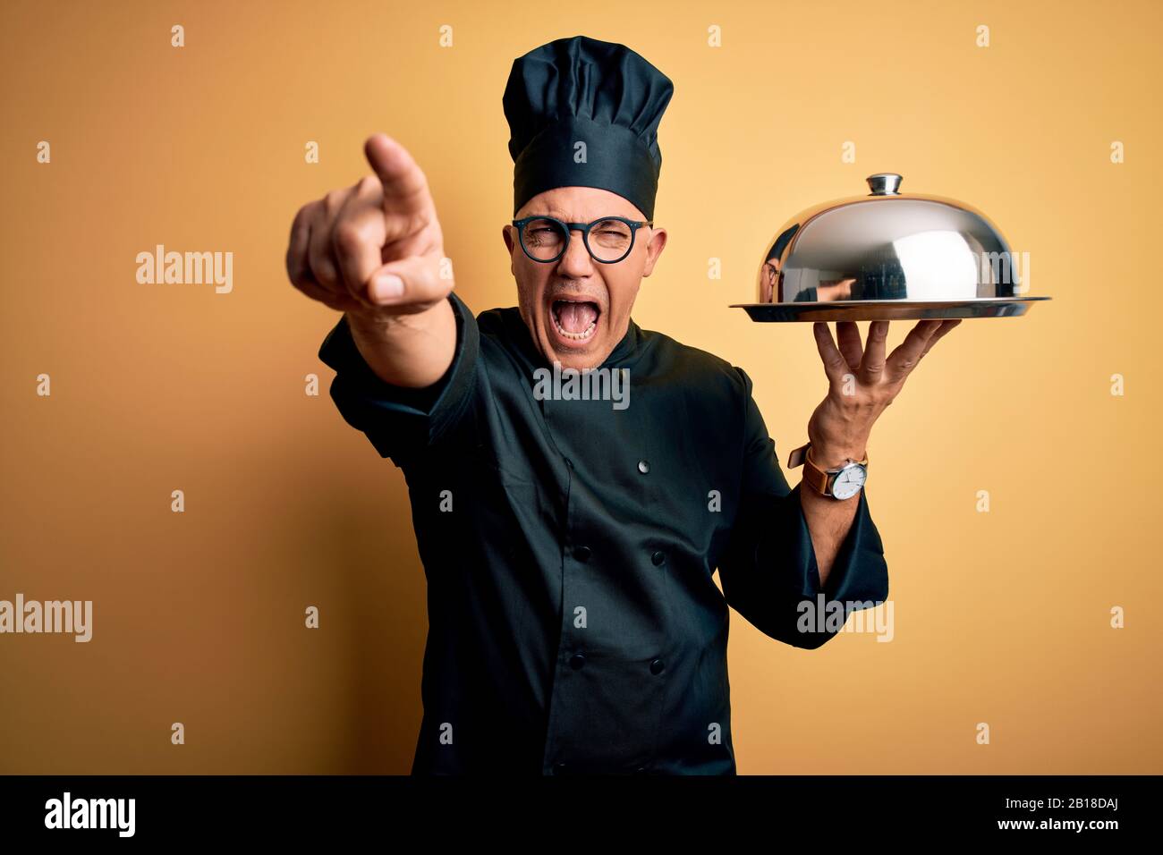 Middle age handsome grey-haired waiter man wearing cooker uniform and ...