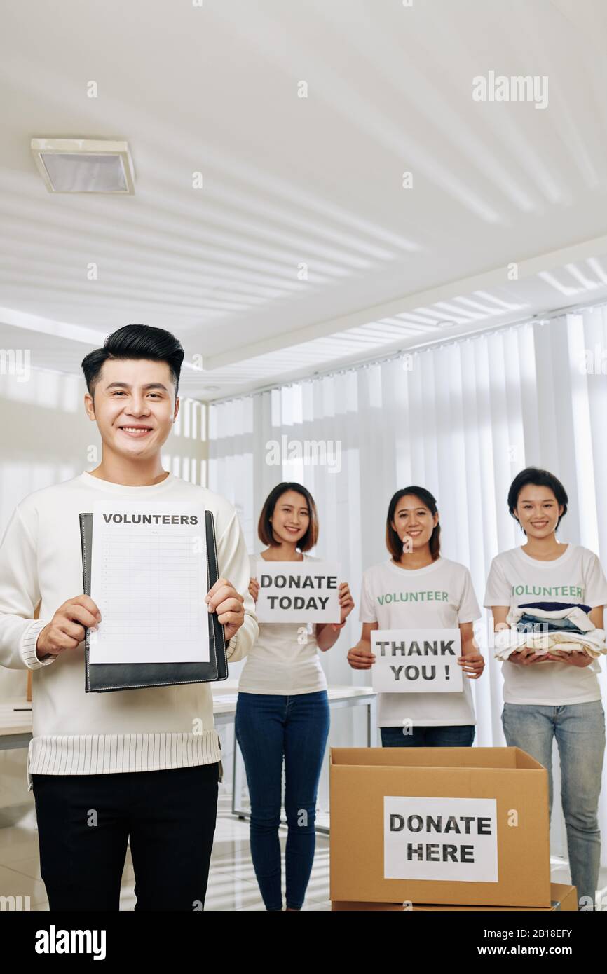 Group of volunteers inviting new members and collecting clothes, food