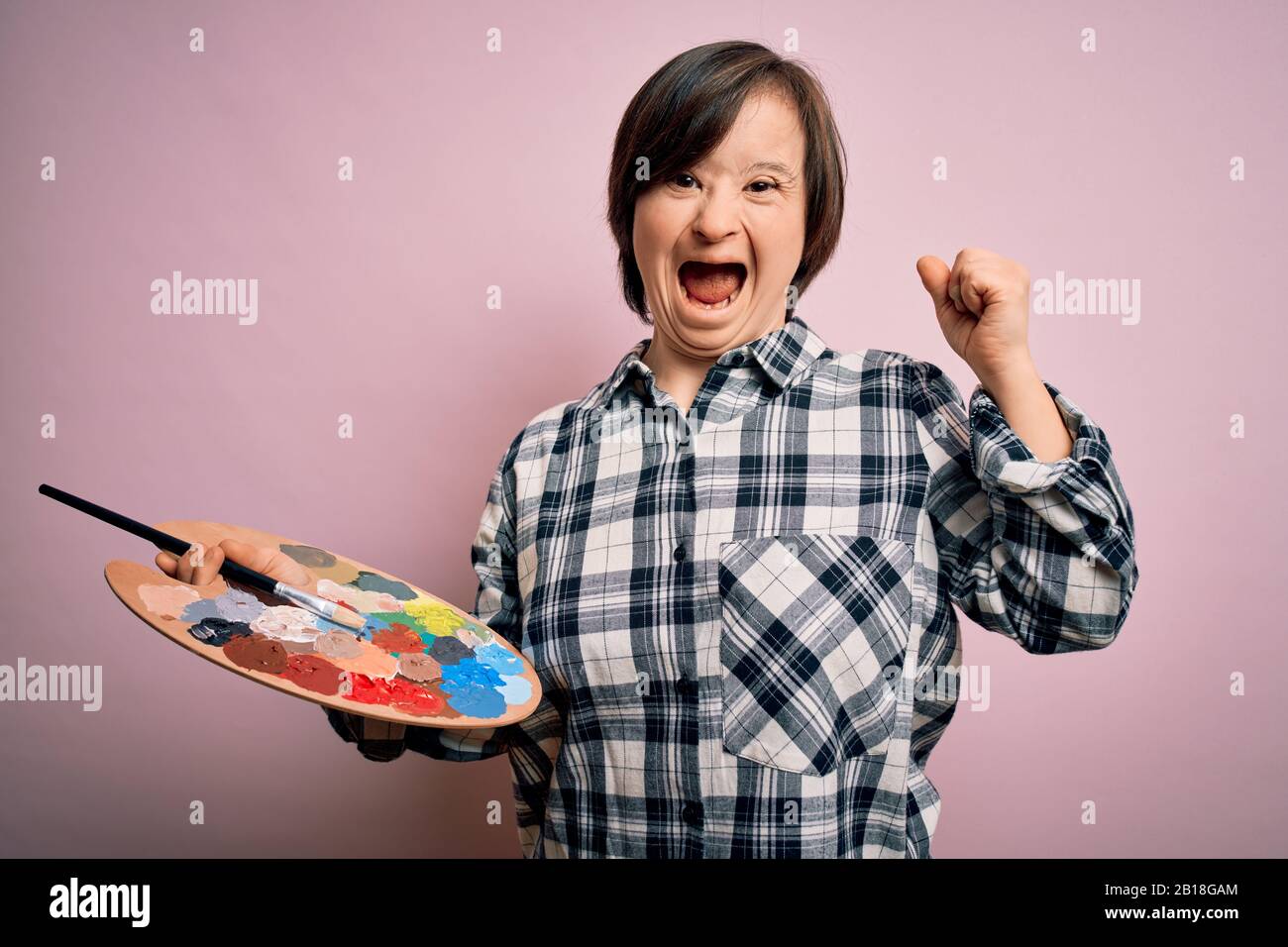 Young Down Syndrome Artist Woman Holding Painter Palette And Paintbrush 