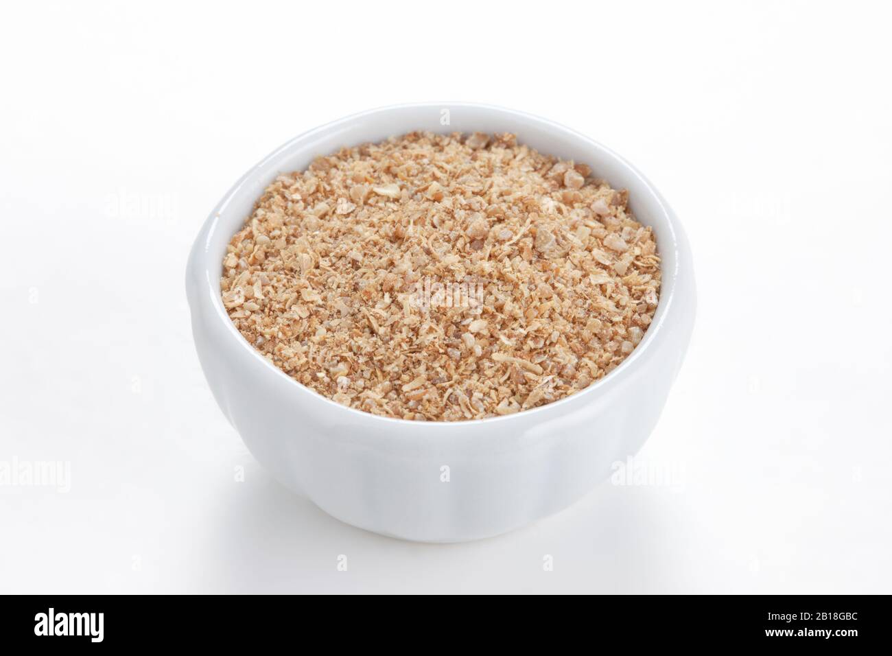 Coriander ground (Coriandrum sativum) in a white bowl on white