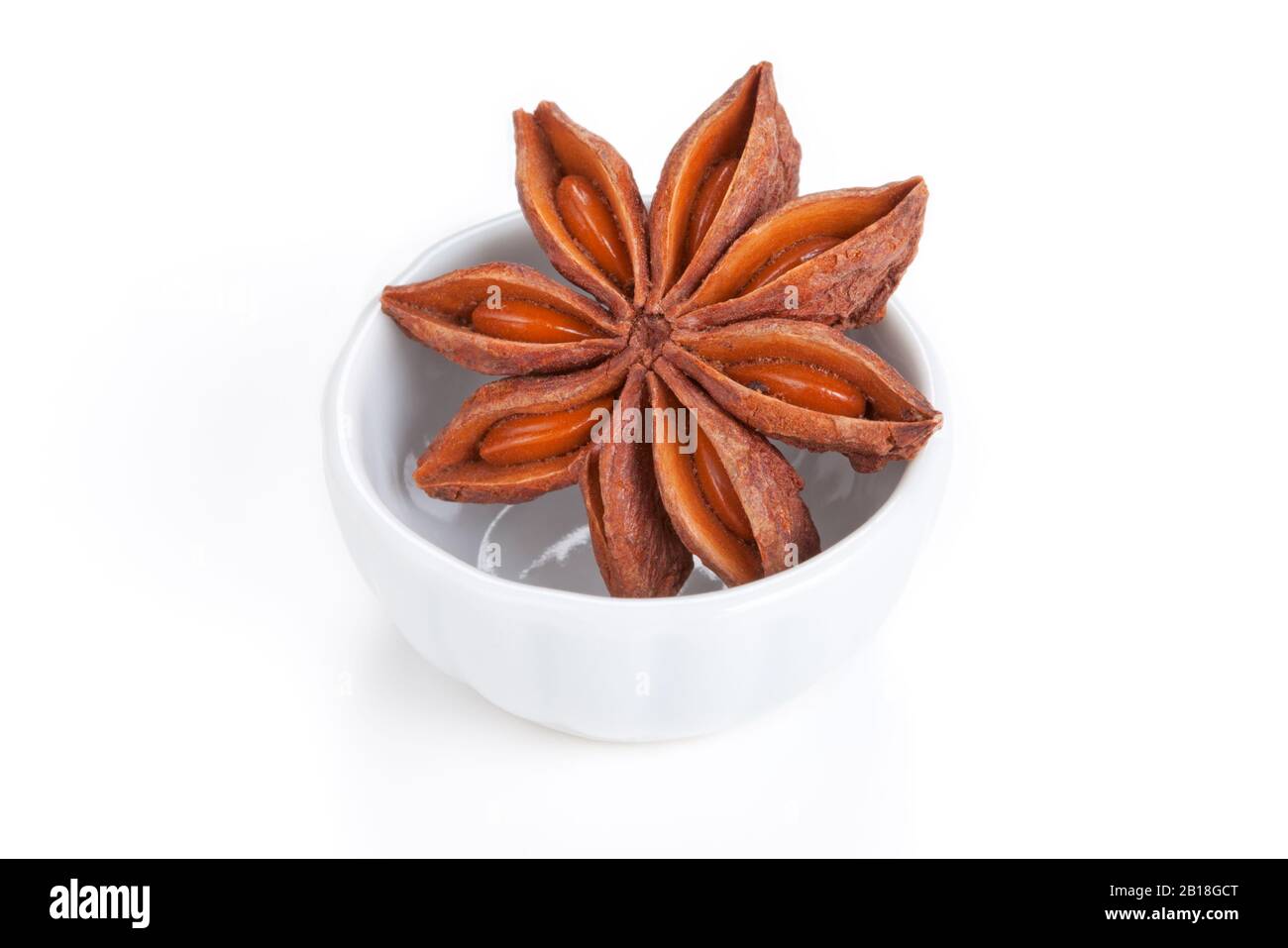 Anise star (Illicium verum) in a white bowl on white background. Also