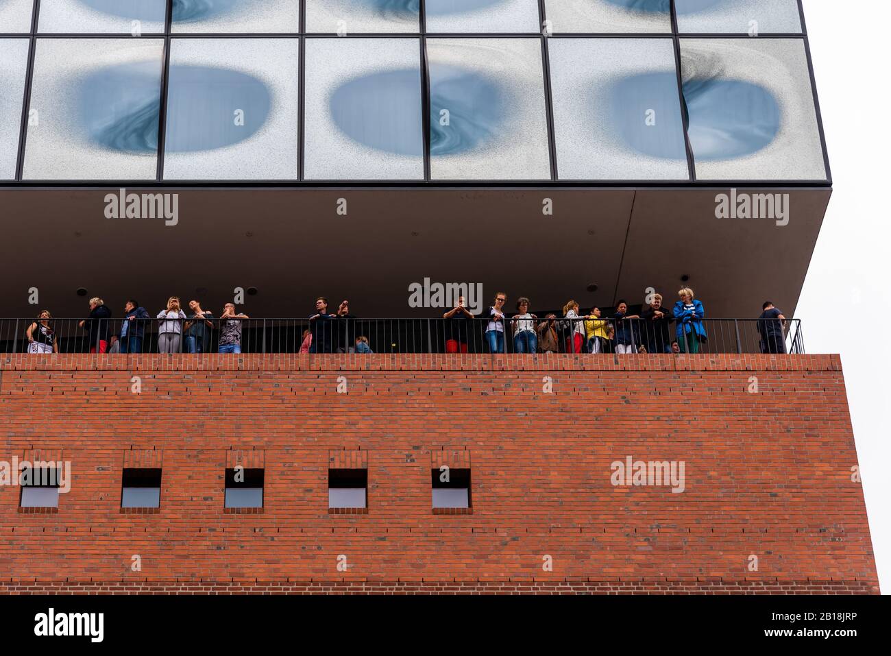 Hamburg, Germany - August 4, 2019: Low angle view of peopkle looking down from the terrace of Elbphilharmonie or Elbe Philharmonic Hall Stock Photo