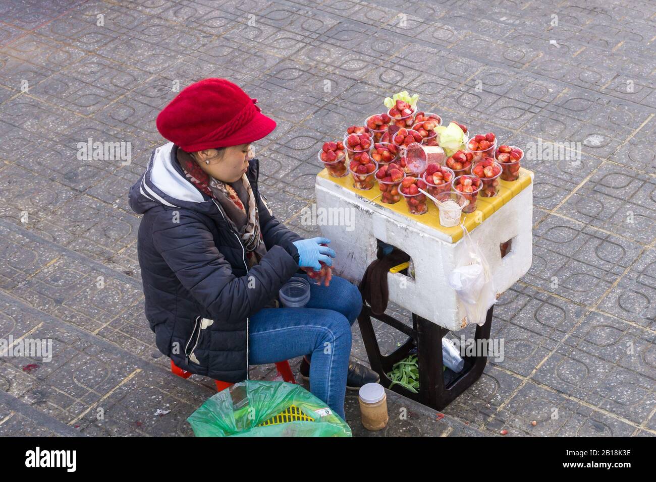 Dalat strawberries - A woman street vendor selling strawberries in Dalat, Vietnam, Southeast Asia. Stock Photo