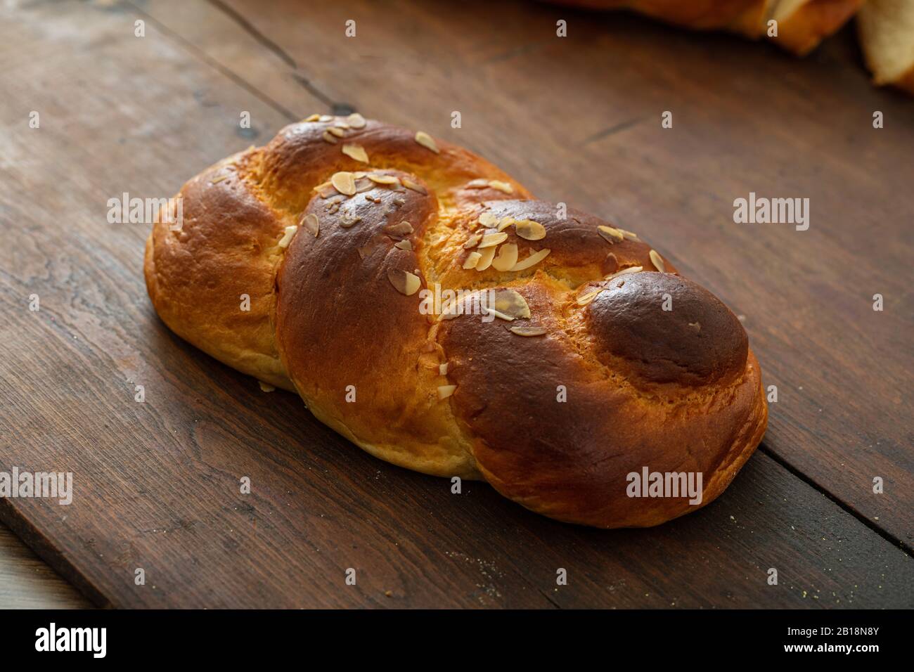 Sweet bread, easter tsoureki, cozonac on wood table background. Braided