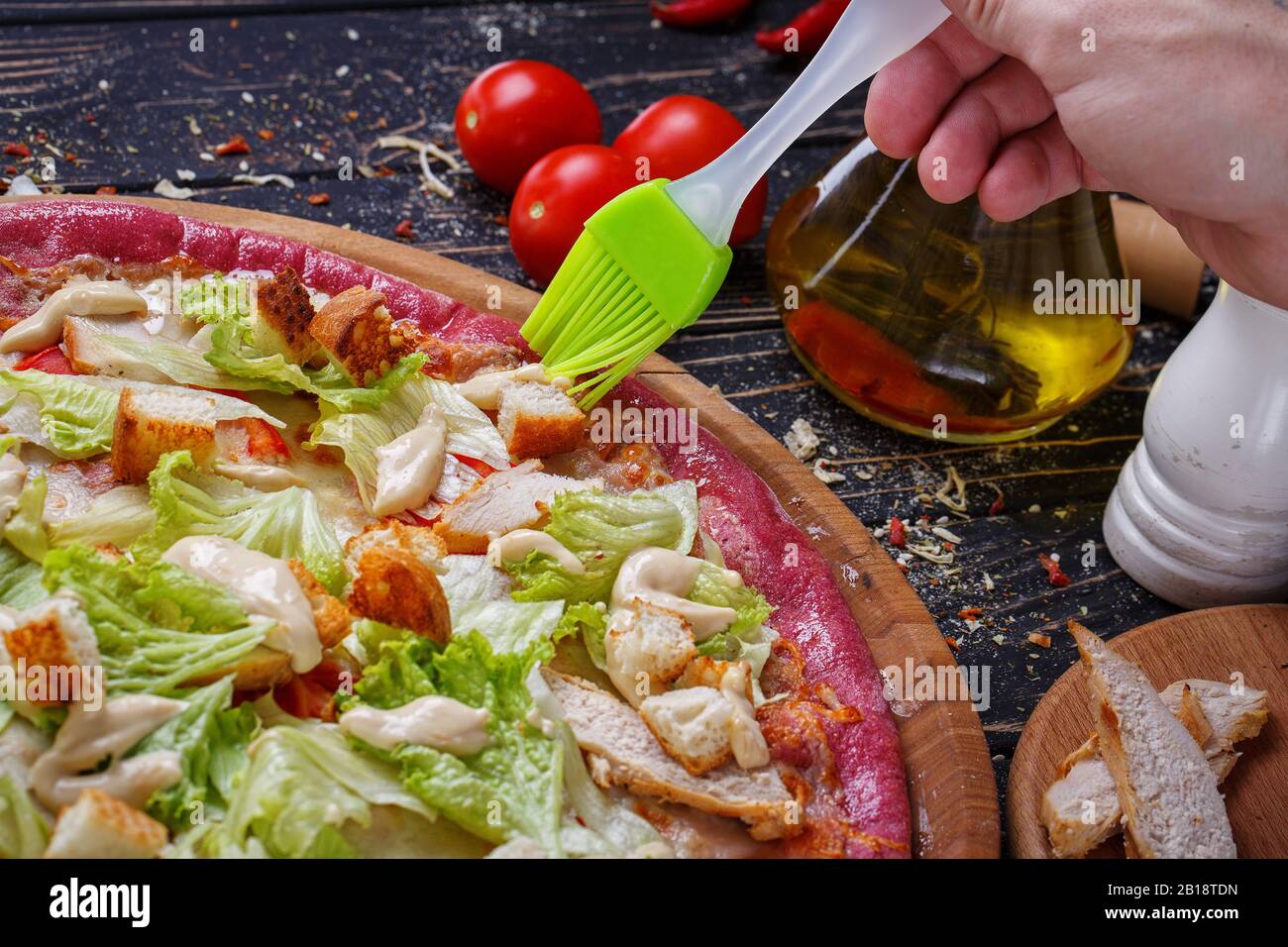 Unusual pizza with chicken meat, slices of white bread, cabbage, tomato