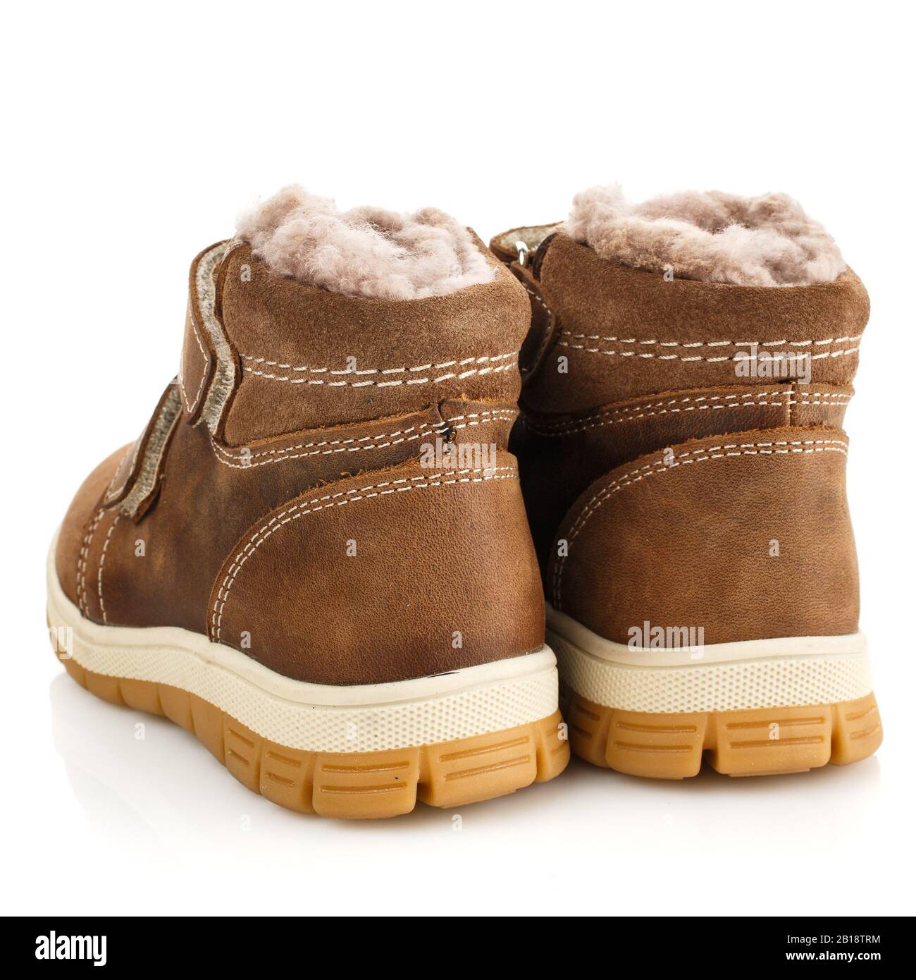 Children's brown winter boots with fur isolated on white. Rear view