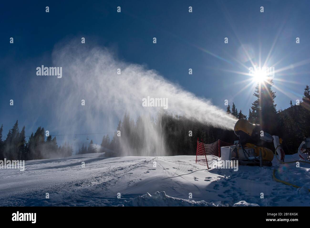 Ski slope with artificial snow machine Stock Photo - Alamy