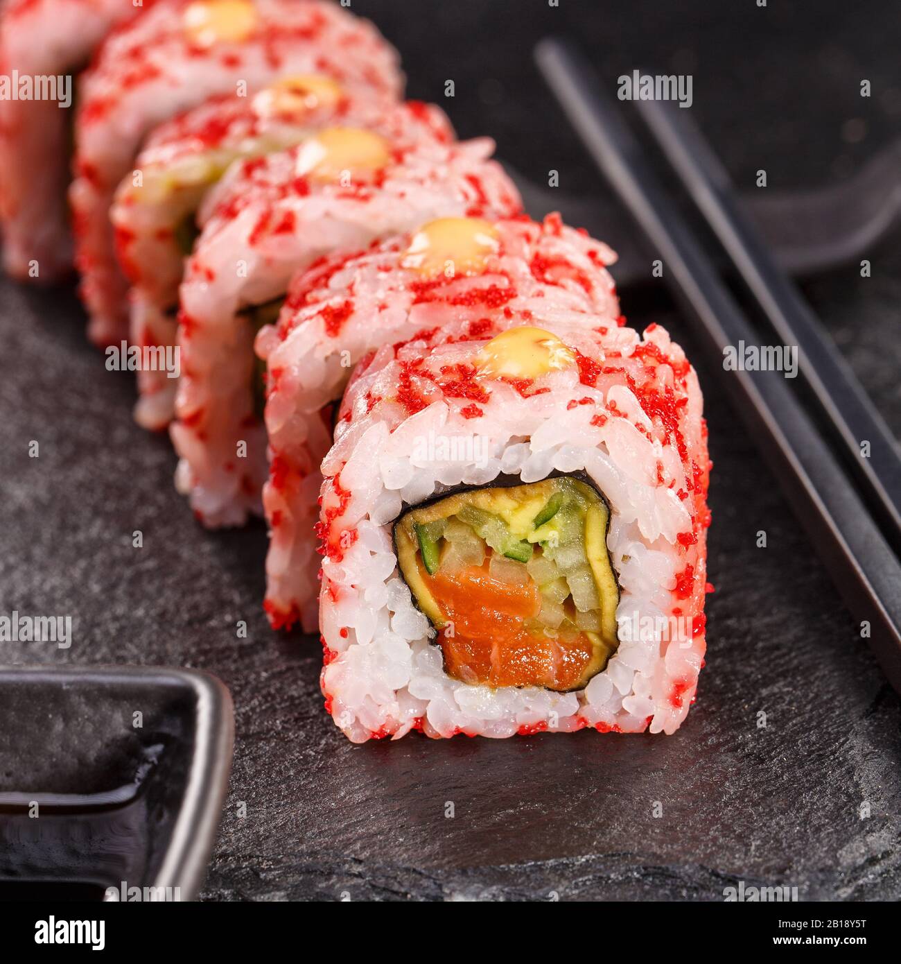 Sushi with chopsticks and soy sauce on a stone board. Japanese food