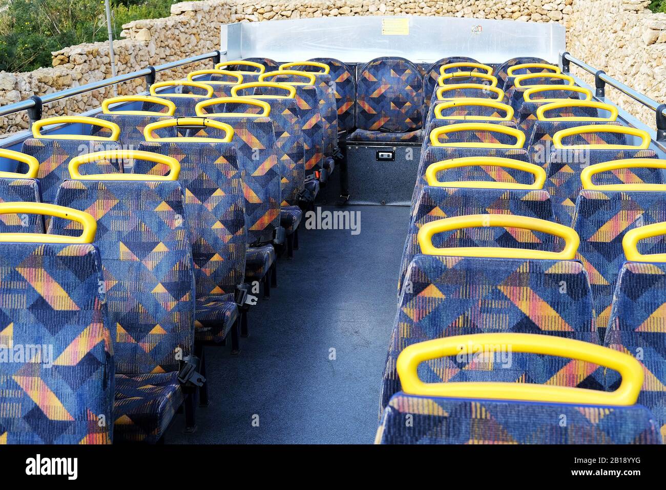 passenger seats on the top deck of a double decker nop-on hop-off bus Stock Photo